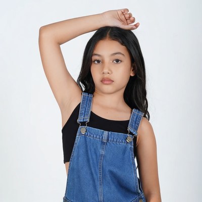 Asian girl in blue overalls posing