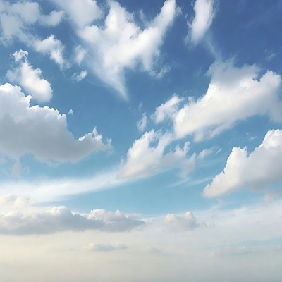 Fluffy white clouds in blue sky