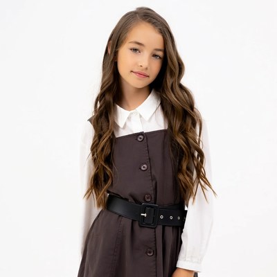 Girl in brown pinafore dress