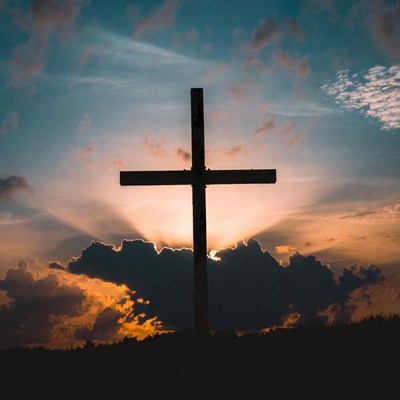 Silhouette cross at sunset