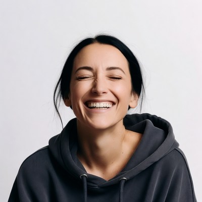 Woman laughing in hoodie