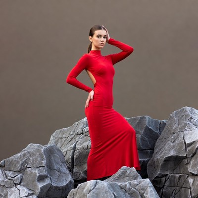 Woman in red dress on rocks