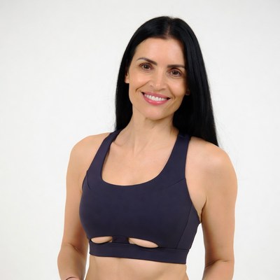 Woman in navy sports bra smiling