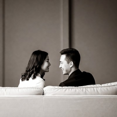 Asian couple smiling on couch