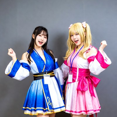 Two women in blue and pink cosplay outfits