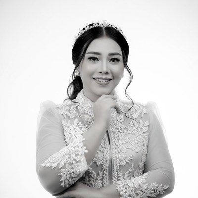 Asian woman in lace dress smiling