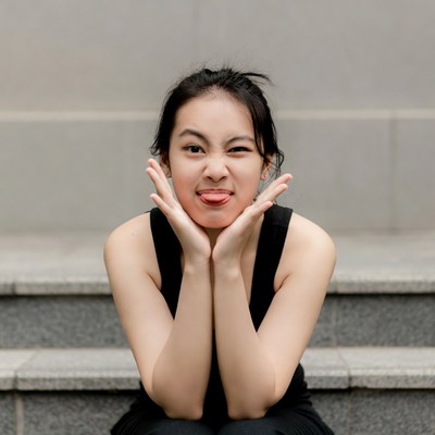 Asian girl sticking tongue out on stairs