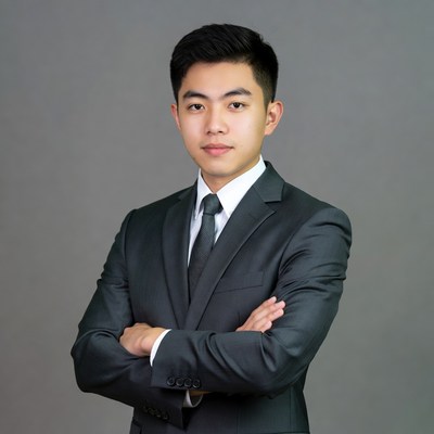 Asian man in suit with arms crossed