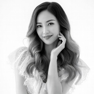 Asian woman touching face with wavy hair