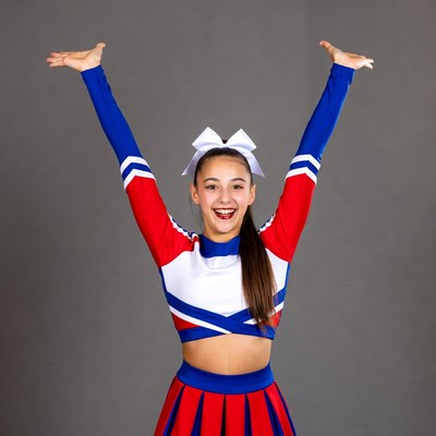 Cheerleader girl raising arms high