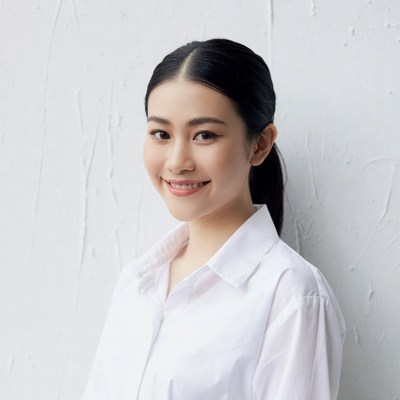 Asian woman smiling in white shirt