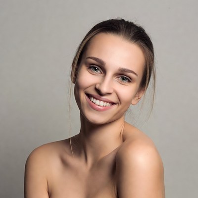 Smiling young woman bare shoulders