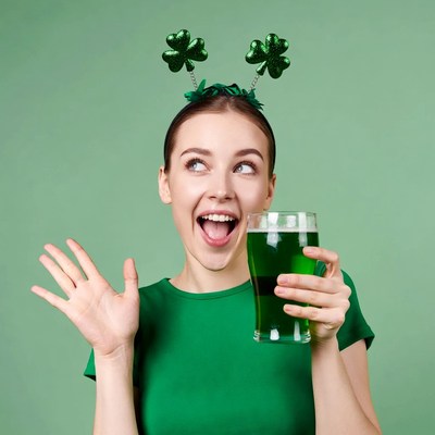 Woman holding green beer shamrock headband