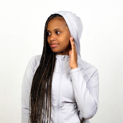 African-American woman in hoodie touching ear