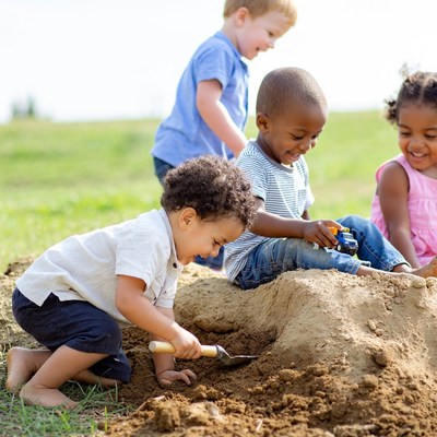 Black boys and girl playing in sand