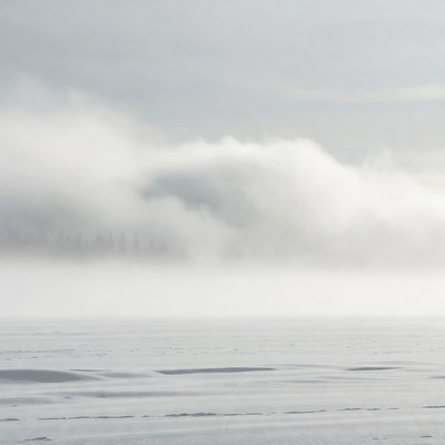 Foggy Clouds over Snowy Landscape