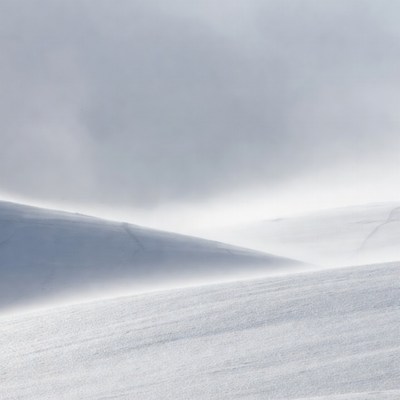 Snowy Hills in Foggy Landscape