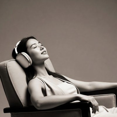 Asian woman relaxing with headphones