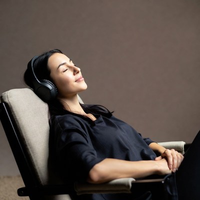 Woman relaxing with headphones in chair