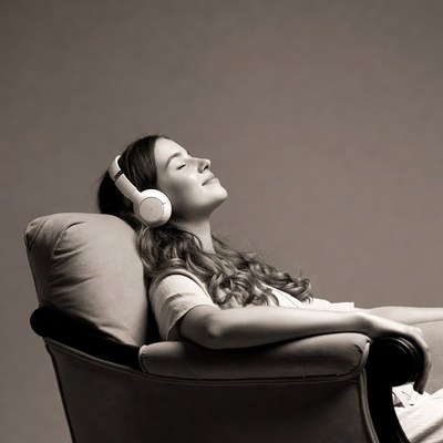 Woman relaxing with headphones on chair