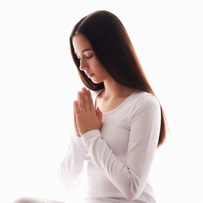 Girl praying with hands clasped