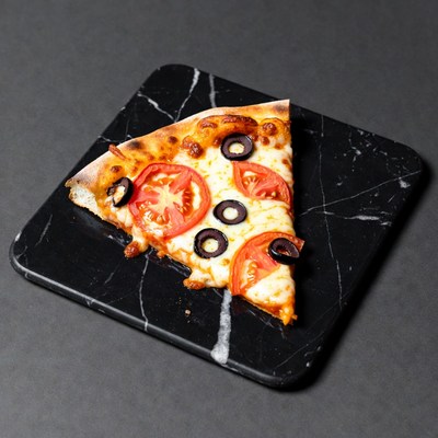 Pizza slice with tomatoes and olives