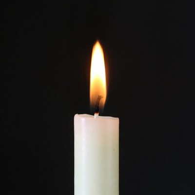 Burning white candle flame