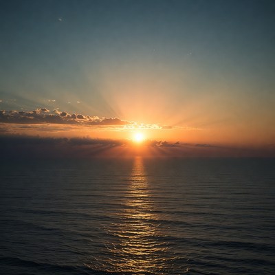 Sunset over ocean with sun rays