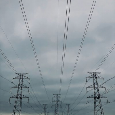 Electricity Pylons Under Cloudy Sky