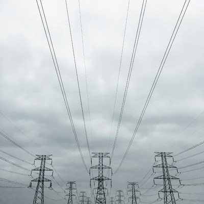 Electricity Pylons Under Cloudy Sky
