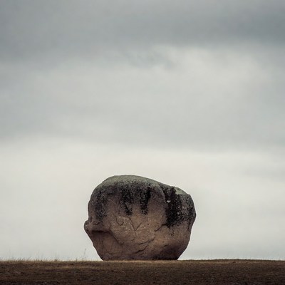 Large Boulder on Grassy Field