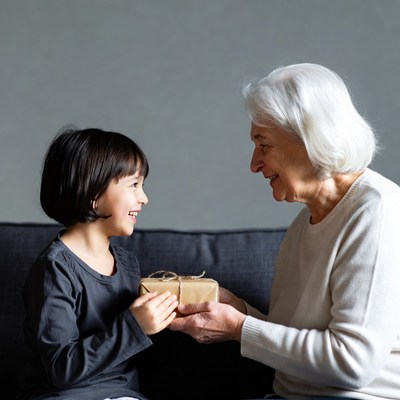 Grandmother receiving gift from boy