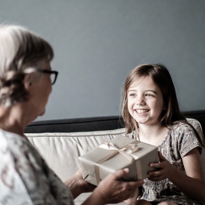 Grandmother giving girl gift