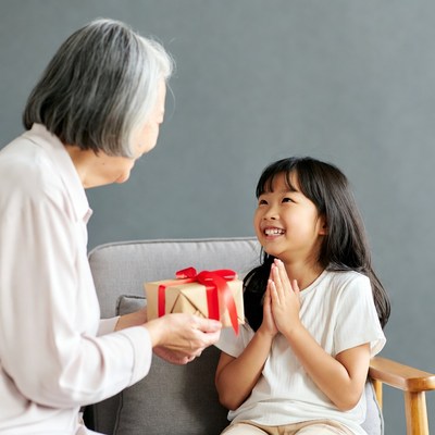 Grandmother giving gift to girl