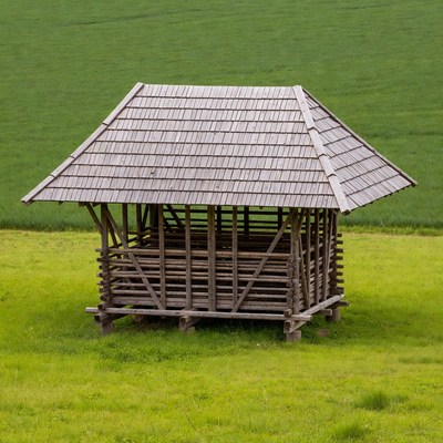 Wooden Hut in Green Field
