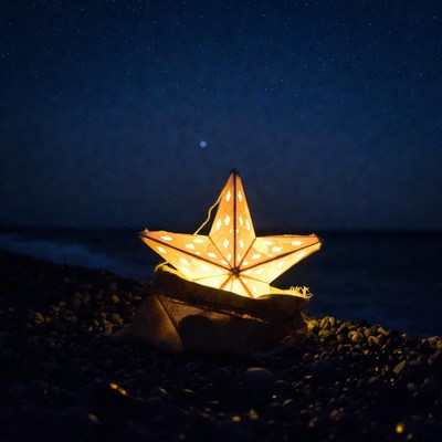Glowing Star Lantern on Beach