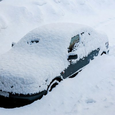 Snow-covered car buried in deep snow