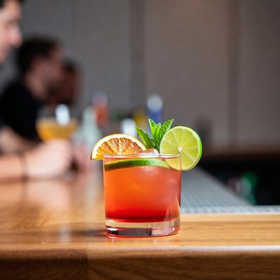 Cocktail with orange lime garnish