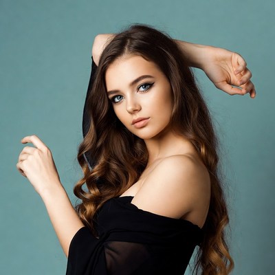Young woman posing with arms raised
