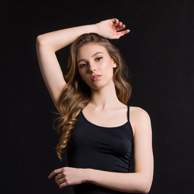 Young woman posing with arm raised