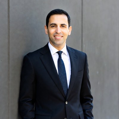 Man in suit against gray wall