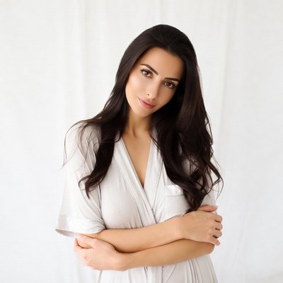 Woman in white robe arms crossed