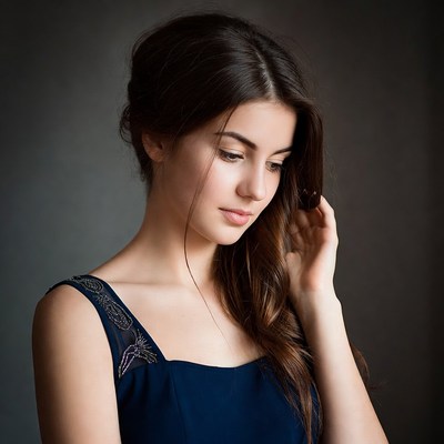 Beautiful woman touching hair thoughtfully