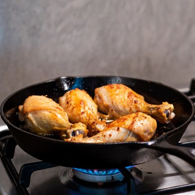 Chicken Drumsticks Cooking in Cast Iron Skillet