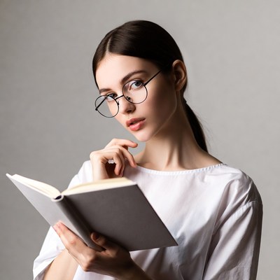 Woman reading book with glasses
