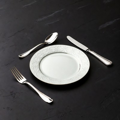 Silverware and White Plate on Black Background