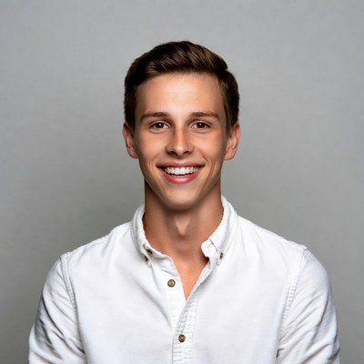 Young man smiling in white shirt