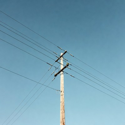 Utility Pole with Wires Against Blue Sky
