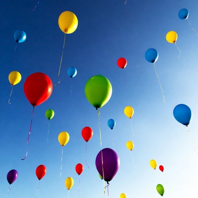 Colorful Balloons Floating in Blue Sky