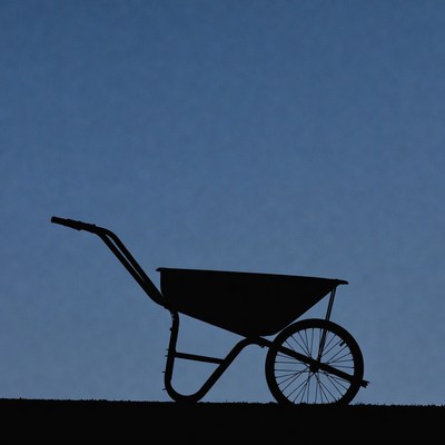 Wheelbarrow silhouette on grass